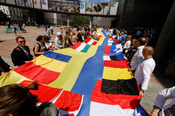 European lawmakers and Ukrainian representatives unfurl a 30-metre-long Ukrainian flag outside EU Parliament, on the day leaders are set to meet to discuss giving Ukraine candidate status to join the European Union, as Russia's invasion of Ukraine continues, in Brussels, Belgium June 23, 2022